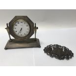 A small silver bedside clock and a silver nurses b