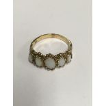 A 9 ct gold ring inset with five opals