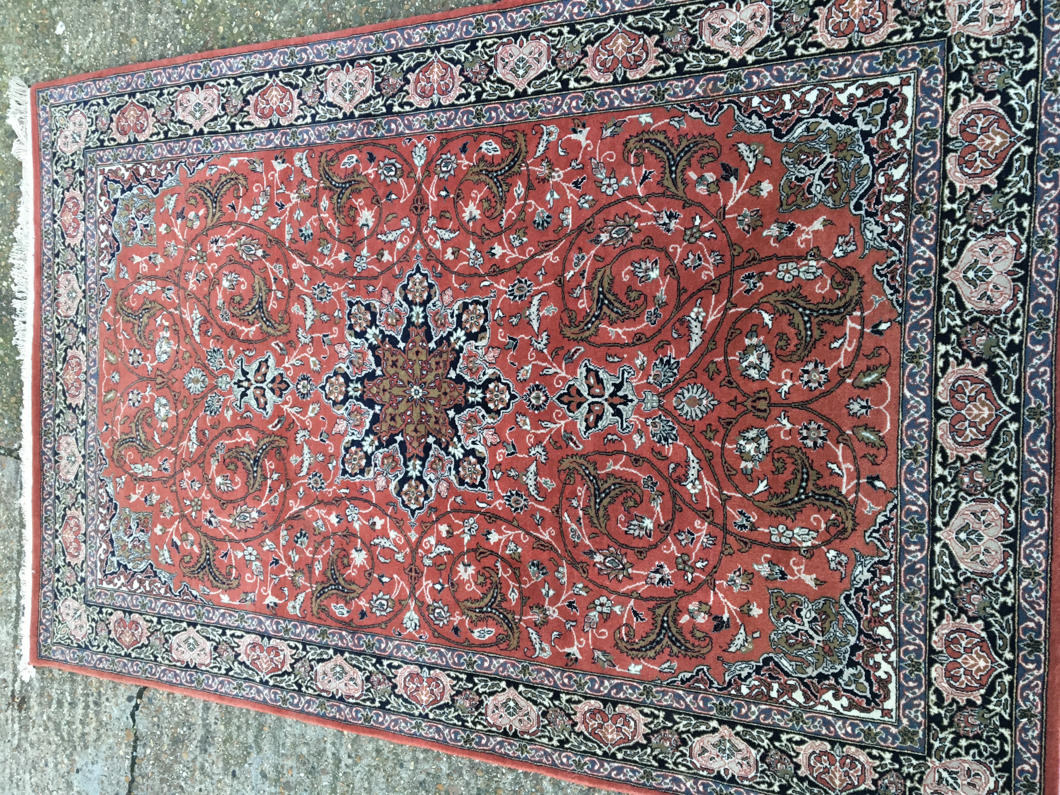 A Persian hand knotted rug with a central star med