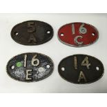 A group of four cast iron carriage number plates