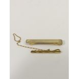 A 9ct gold tie clip and one other