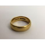 A 22ct gold wedding band ring.Approx 10.6G, P