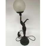 An Art Deco style table lamp of a female figure ho