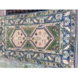 Two hand knotted rugs both with a geometric patter