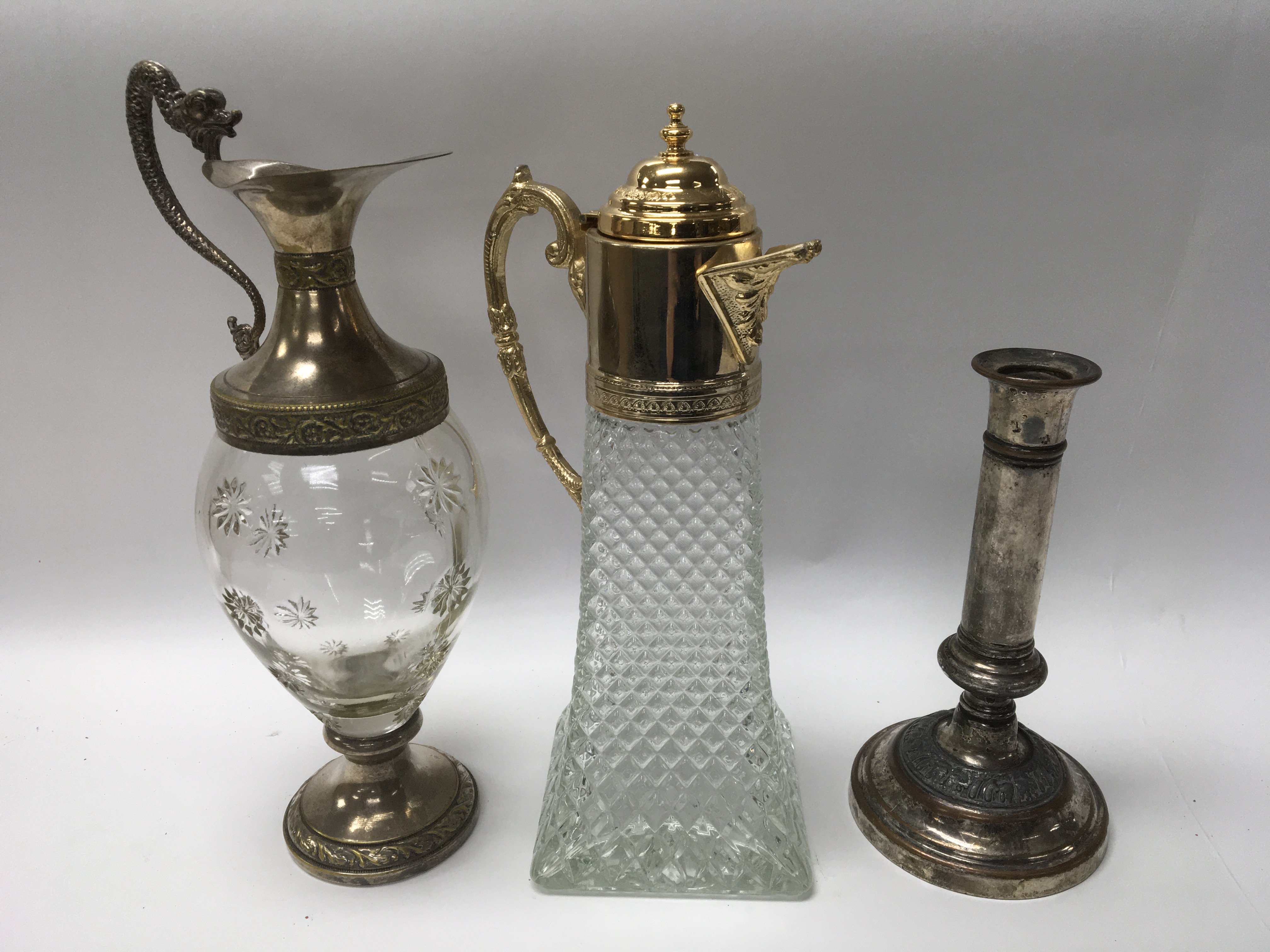 A pair of glass claret jug decanters and a silver