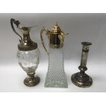 A pair of glass claret jug decanters and a silver