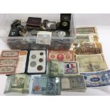A box of various coinage and bank notes.