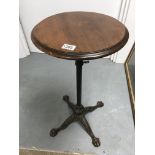 A Victorian adjustable table the circular top abov