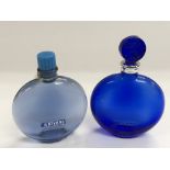 Two circular Lalique blue glass perfume bottles, a