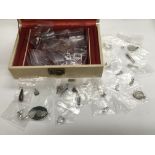 A jewellery box of silver charms and pendants.
