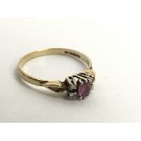 A 9ct gold ring set with ruby or possible pink sap