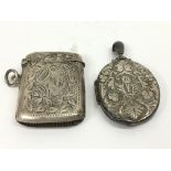 An engraved silver vest case and locket.Approx 37g