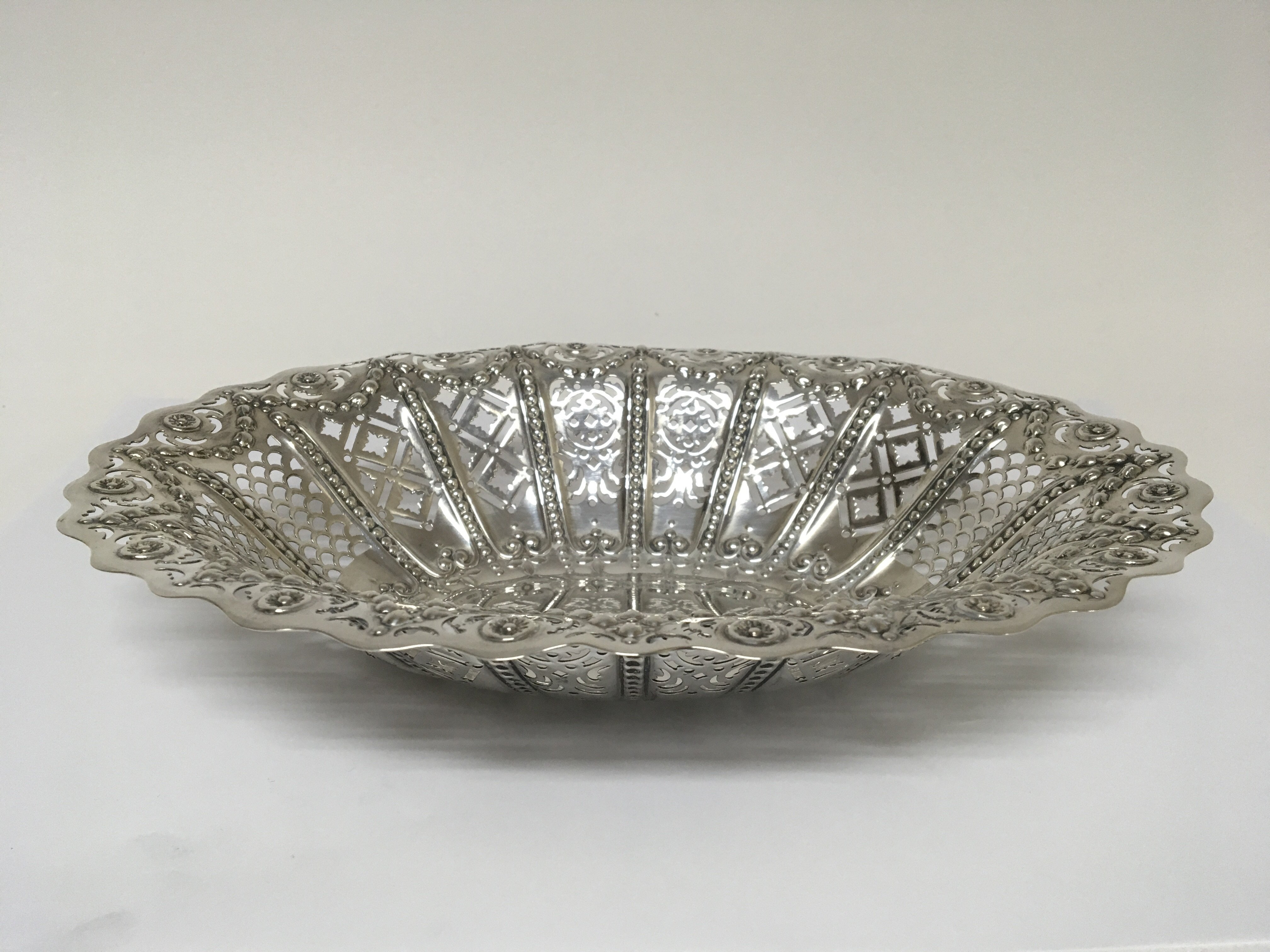 A silver table basket with pierced sides and garla