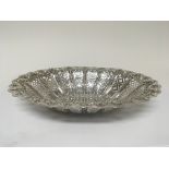 A silver table basket with pierced sides and garla