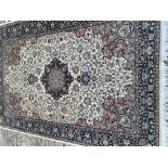 A Persian part silk hand knotted rug with a floral