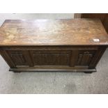 A oak blanket box with panel front ,