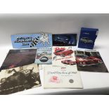 A box containing a collection of car sales brochur