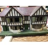 A large pre war. Triang dolls house with garage ,