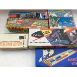 A box containing a collection of boxed tinplate reproduction clockwork/ battery operated toys