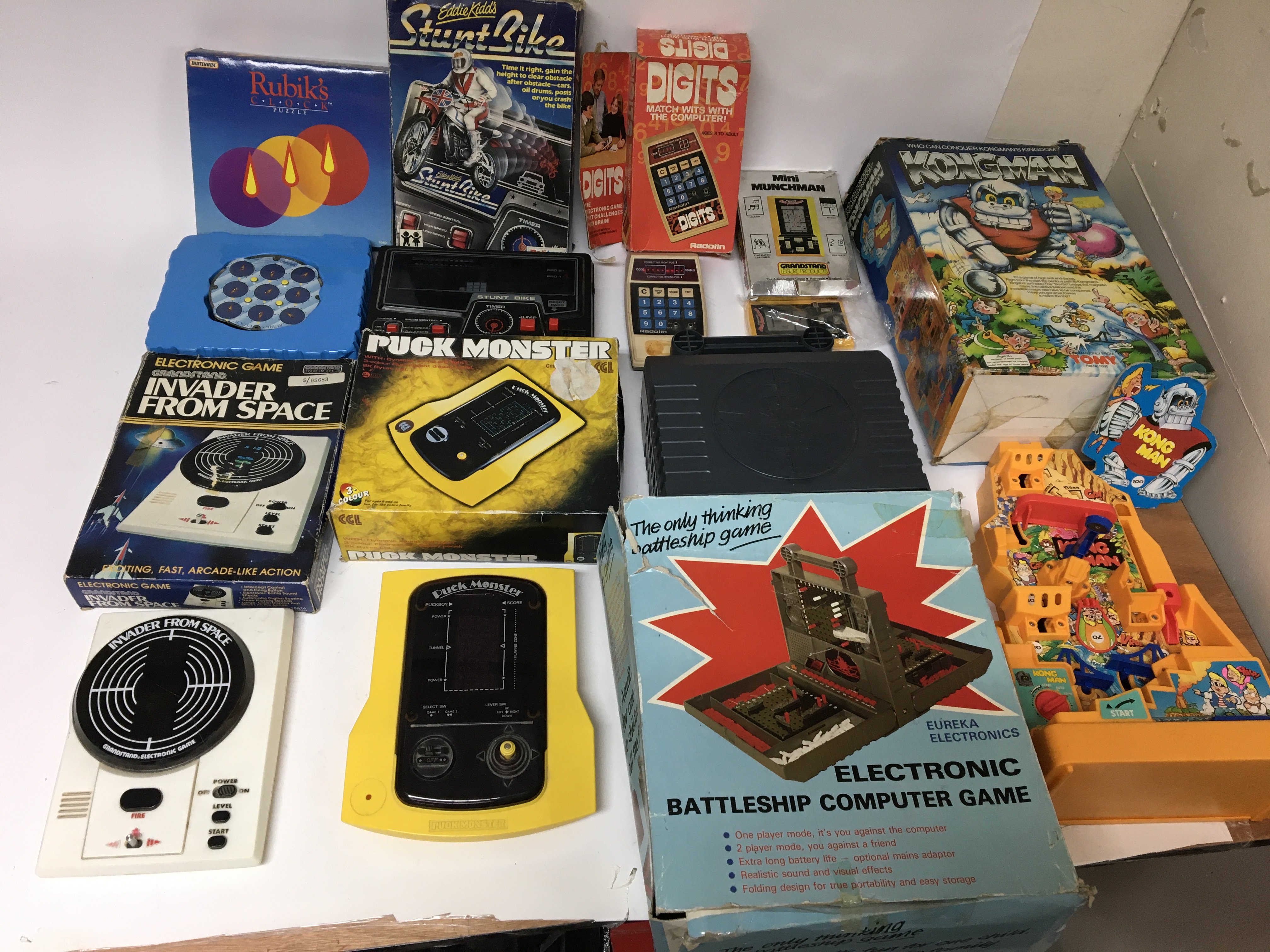 A box of 1980s games machines and mechanical toys
