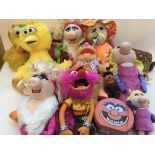 A box containing a collection of plush Muppets including Miss piggy, Animal, Fozzie bear etc