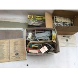A box containing a collection of Railway OO scale accessories