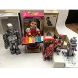 A collection of boxed tinplate reproduction clockwork toys including Robots etc