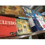 A collection of boxed board games including Go, Buccaneer, Cluedo, Railroader, electronic radio