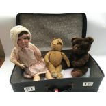 A case that includes a 1930s dressed doll , not original clothing and two Teddy Bears, playworn