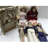 A box containing a collection of dolls including a