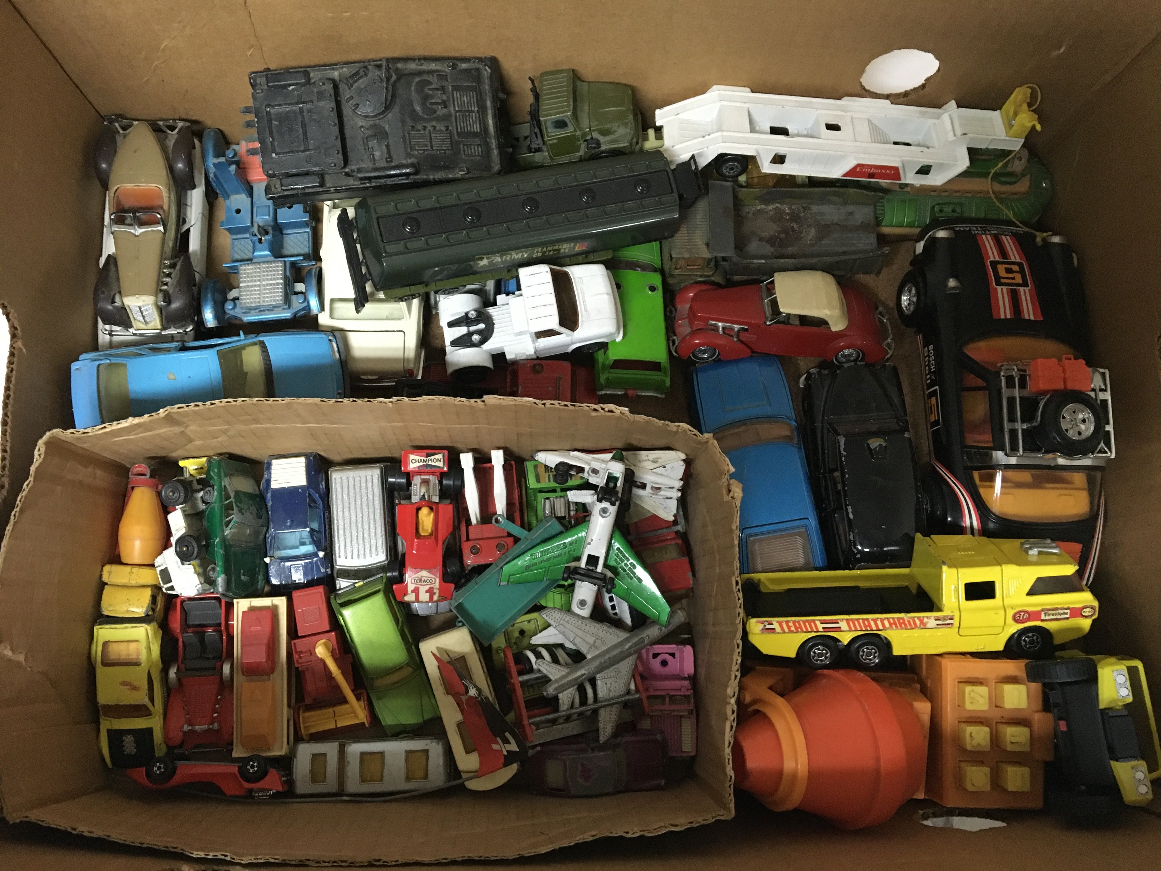 A box containing a collection of loose diecast veh
