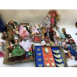 A box containing a collection of dolls and dolls c