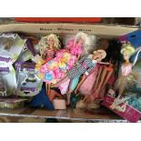 A large collection of loose Barbie and type dolls and other carded toys