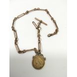 An 1899 full sovereign on 9ct rose gold fob chain.Approx 21g