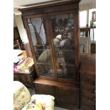 A Victorian mahogany bookcase cupboard the pair of glazed doors above cupboards doors .