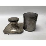 A silver inkwell and a silver cylindrical Mappings