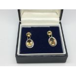 A pair of citrine drop earrings.