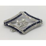 An 18ct white gold sapphire and diamond brooch with pearl. Diamonds 0.35ct. Sapphires 3.71ct