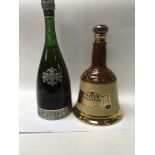A bottle of bells scotch whisky and a bottle of segura viudas