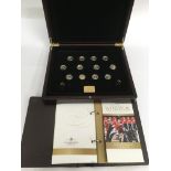 A wooden cased 'The Royal House of Windsor' gold coin collection, comprising twelve 9ct gold coins