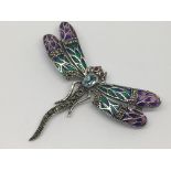 A silver dragonfly brooch set with topaz, coloured enamel, marcasite and ruby eyes
