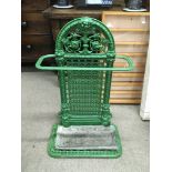 A wrought iron stick stand, painted green.