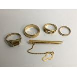 Three gent's gold rings, one 18ct, a wedding band and a 9ct gold tie pin.Approx 25g