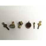 A gold watch, fob watch seals and keys