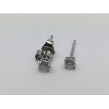 A pair of 18ct white gold diamond stud earrings, approx