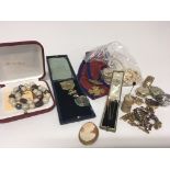 A collection of watches stick pins a Victorian Commemorative medal and costume jewellery.