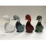 Four Whitefriars figures of ducks in red, green, blue and clear glass examples, approx height 14cm.