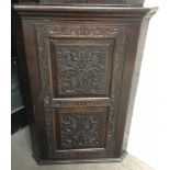 A large, carved oak corner cabinet.Approx 72x100x50cm deep.