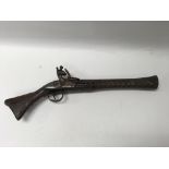 An eastern flintlock pistol with intricately designed barrel.