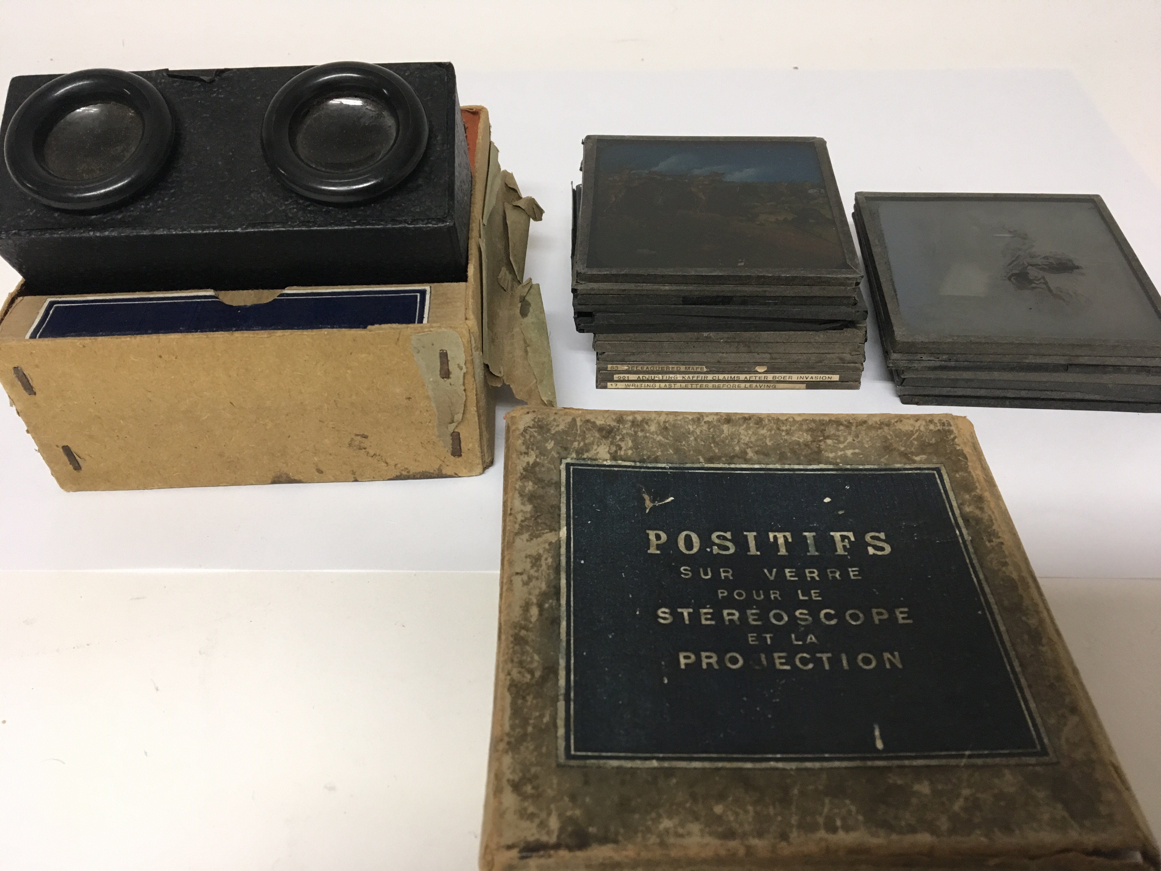 A collection of coloured lantern slides with images of late Victorian and later battle scene and a